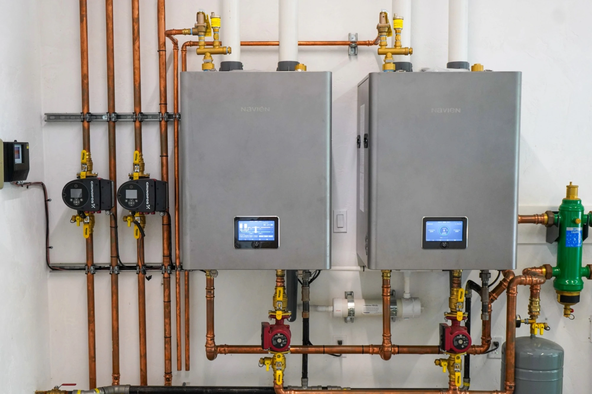 High-efficiency Navien boiler system installation with copper piping and modern HVAC controls for residential heating.